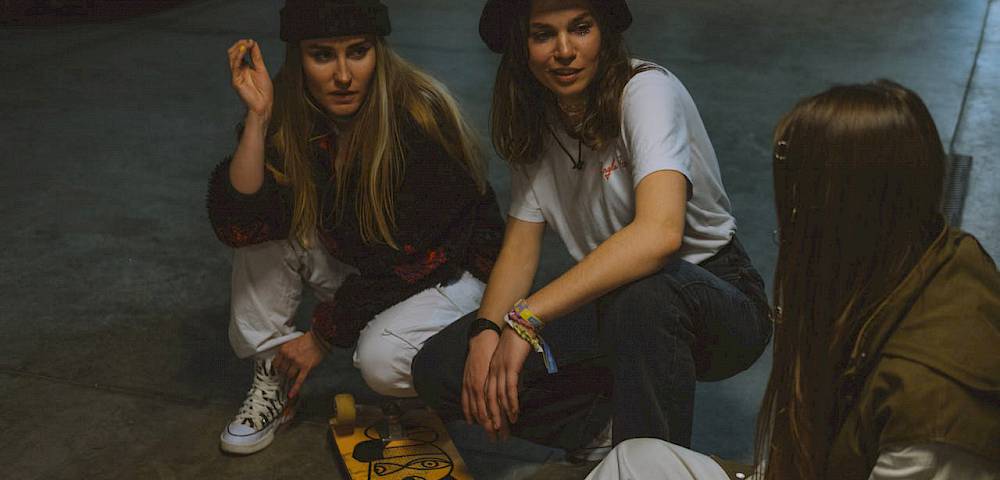3 Mädchen mit Board sitzend